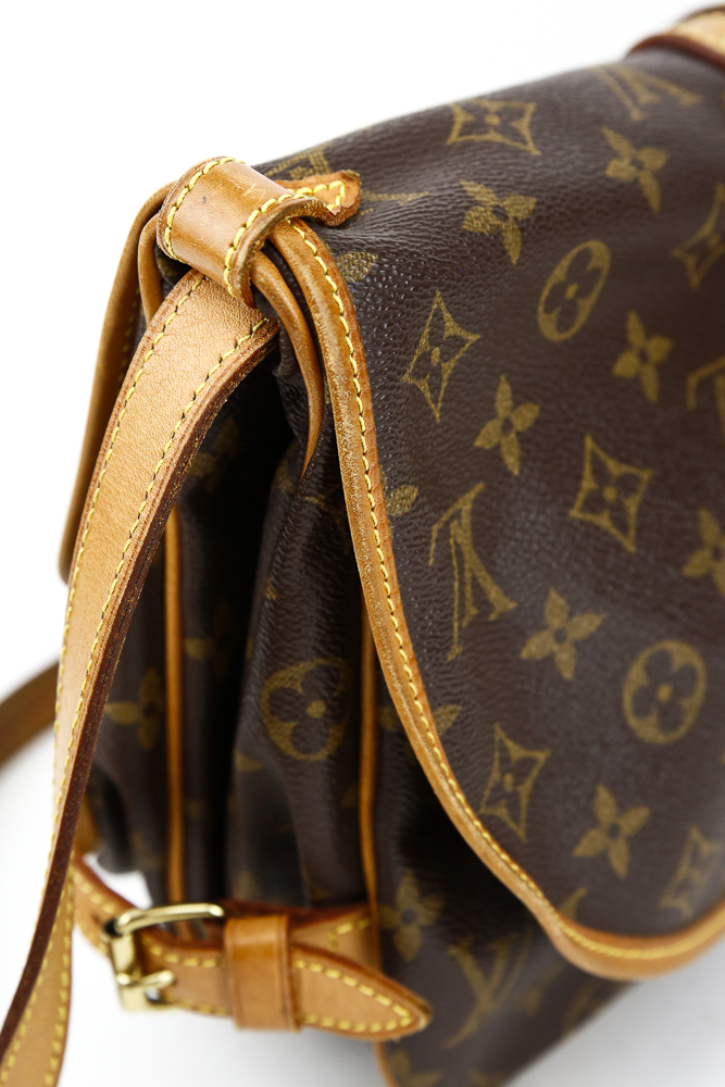 corner view of Louis Vuitton Monogram Coated Canvas Saumur 25 Satchel